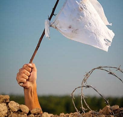 Arm Holding White Flag On The Battlefield