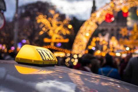 Taxi Car At City Street Near Christmas Market In Rathausplatz, Vienna, Austria